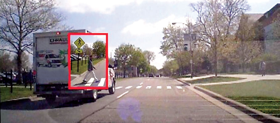 Photo of a U-Haul truck stopped at a cross-walk; the CANVAS car can "see" the pedestrian crossing from behind the truck.